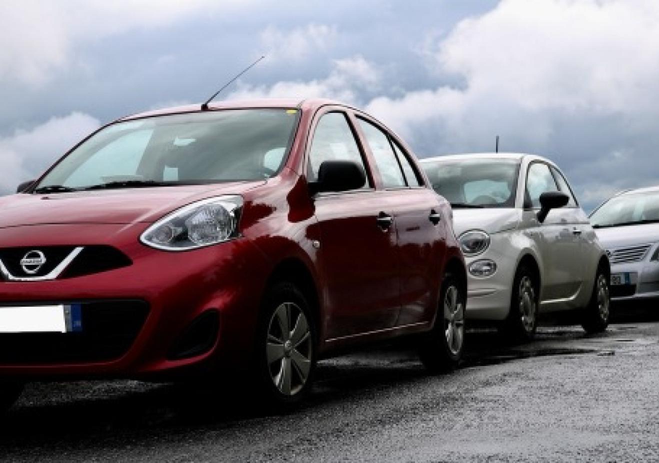 Three cars parked on a road