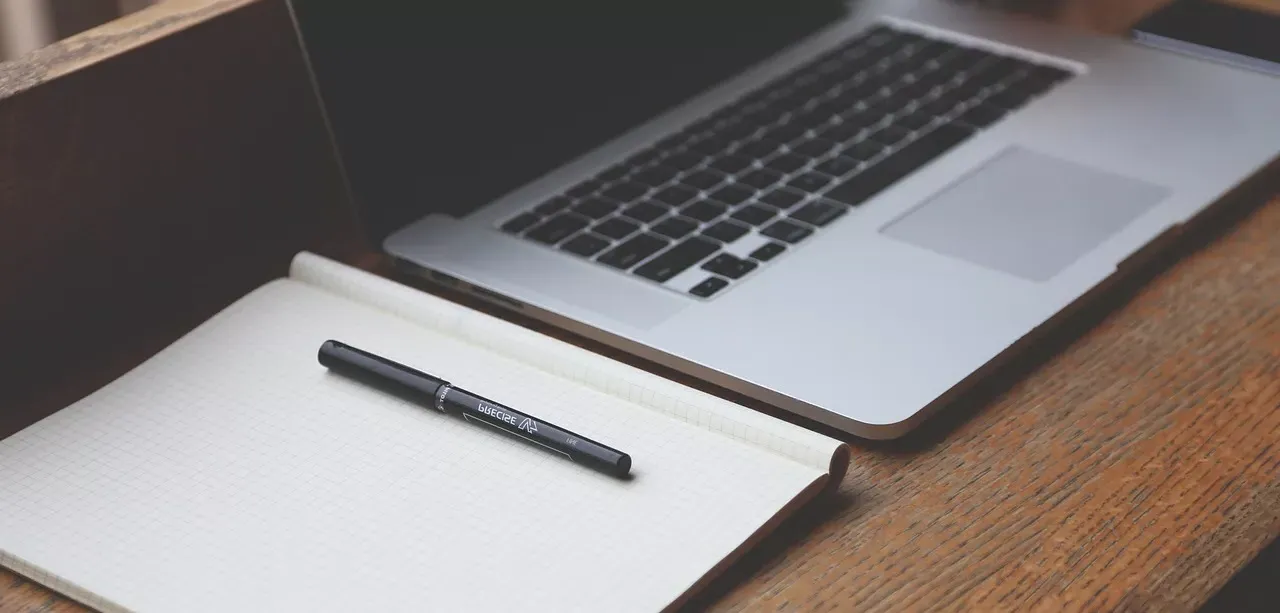 Laptop and Notebook on a Desk